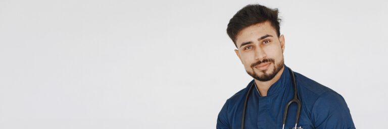 Man in Blue Scrub Suit Holding a Patient Record